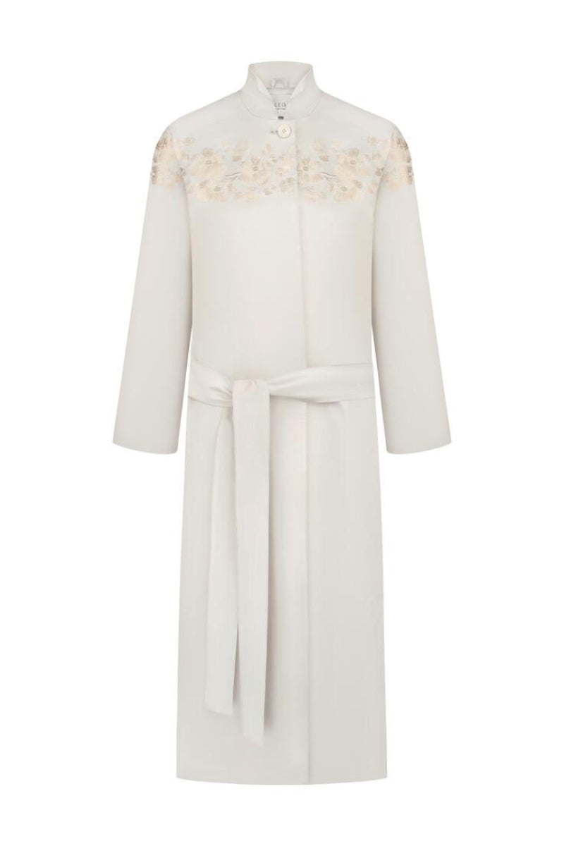 Petal grey beige trench coat by DELEGAN displayed on a ghost mannequin, front view showcasing classic design and fabric details.