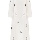 Ivory midi dress with white ornamental details on a mannequin, featuring a fitted bodice and flowing skirt by DELEGAN.