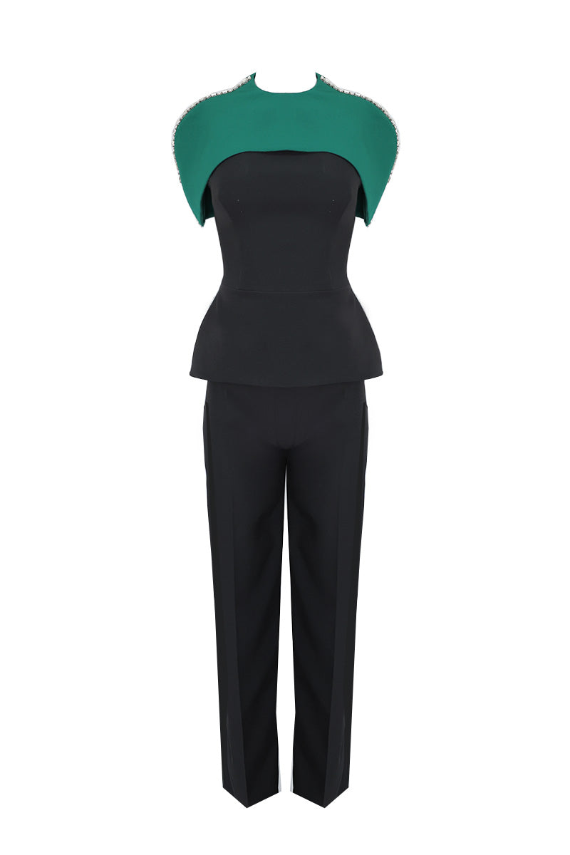 Joanna Andraos midnight black co-ords set featuring top and pants with a detachable emerald cape, front view.