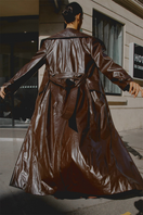 Brown Gabrielle faux leather trench coat by Gigii's, stylish long coat with classic design and button details.