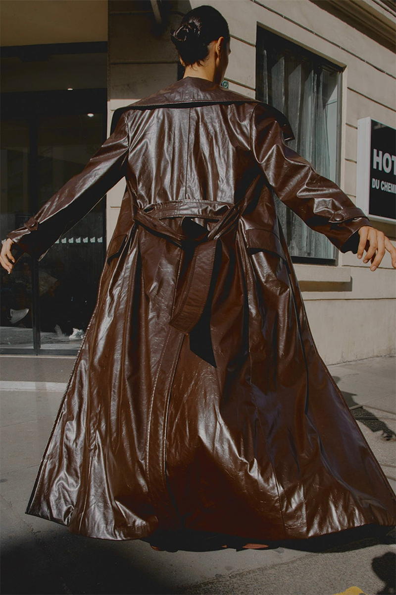 Brown Gabrielle faux leather trench coat by Gigii's, stylish long coat with classic design and button details.