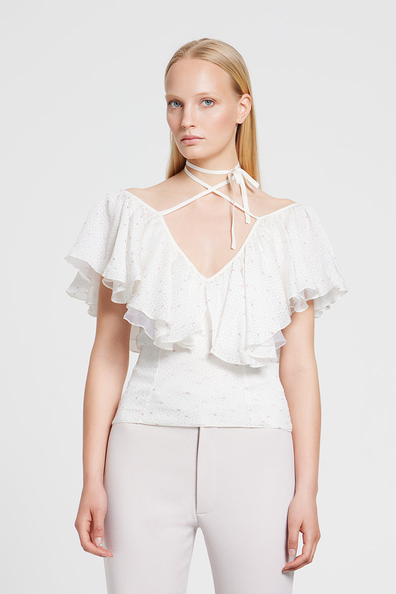 White Nara Niro GIGI TOP, a stylish women's blouse with a relaxed fit and elegant design, displayed on a mannequin.