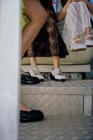 Black Gvasalia slingback heels with decorative gems, featuring a stylish open-back design and pointed toe.