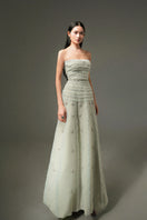 HAPPY CLOTHING CULT MIA X strapless gown in soft mint gray with stone organza fabric, featuring a flowing, elegant design.