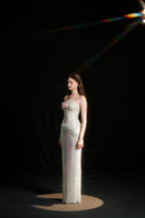 Elegant ivory sequin gown featuring a draped corset design by HACCHIC COUTURE, perfect for formal events.