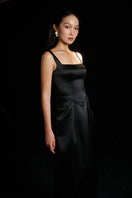 Black Amelia strap gown by HACCHIC COUTURE featuring a sleek design and elegant fit, showcased in a stylish lookbook image.