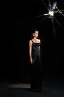Black Amelia strap dress by HACCHIC COUTURE, elegant gown with fitted bodice and flowing skirt, showcased in a stylish fashion lookbook image.