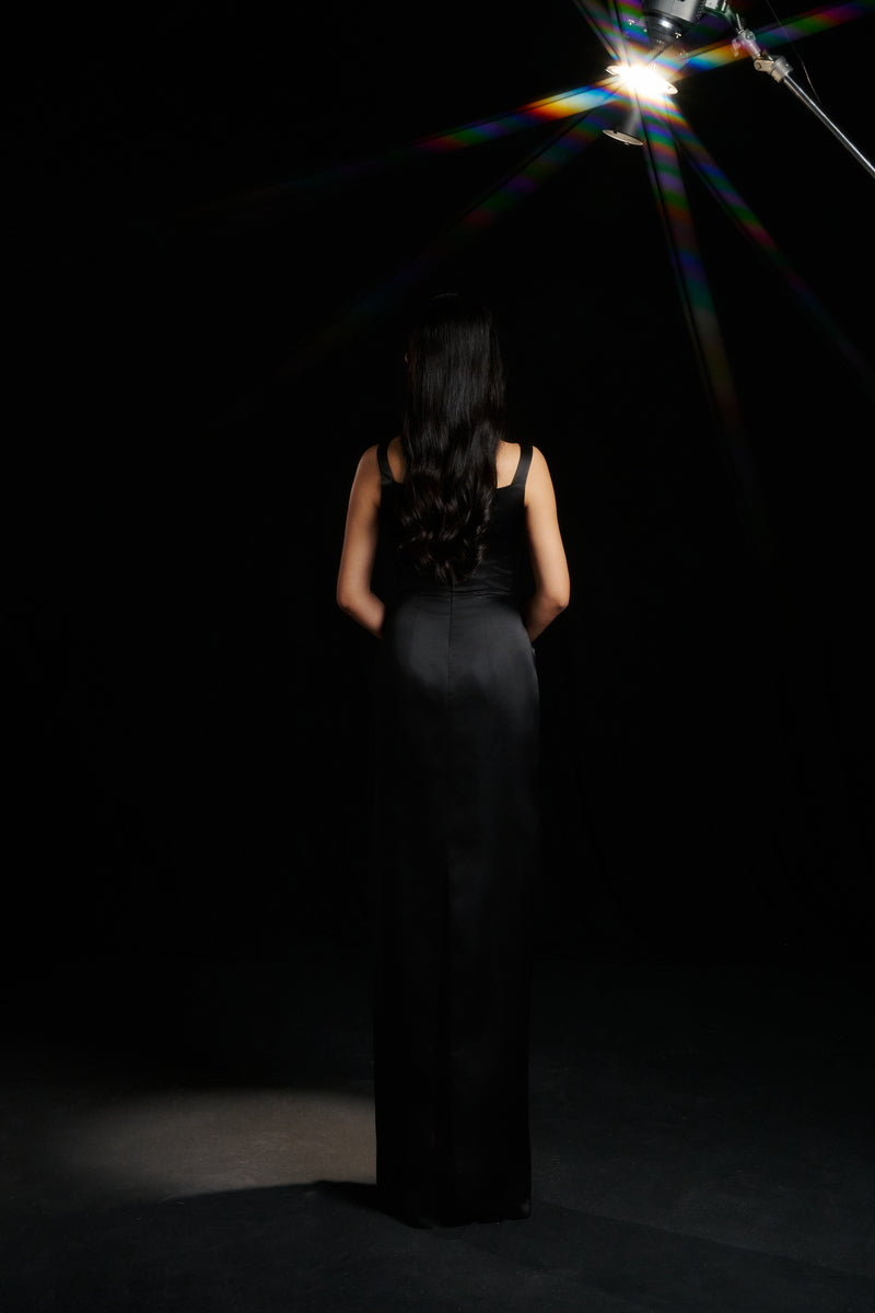 Black Amelia strap gown by HACCHIC COUTURE, featuring elegant design and sleek fabric, perfect for formal occasions.