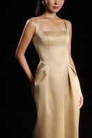 Light yellow Amelia strap dress by HACCHIC COUTURE featuring elegant gown design with thin straps and flowing fabric.