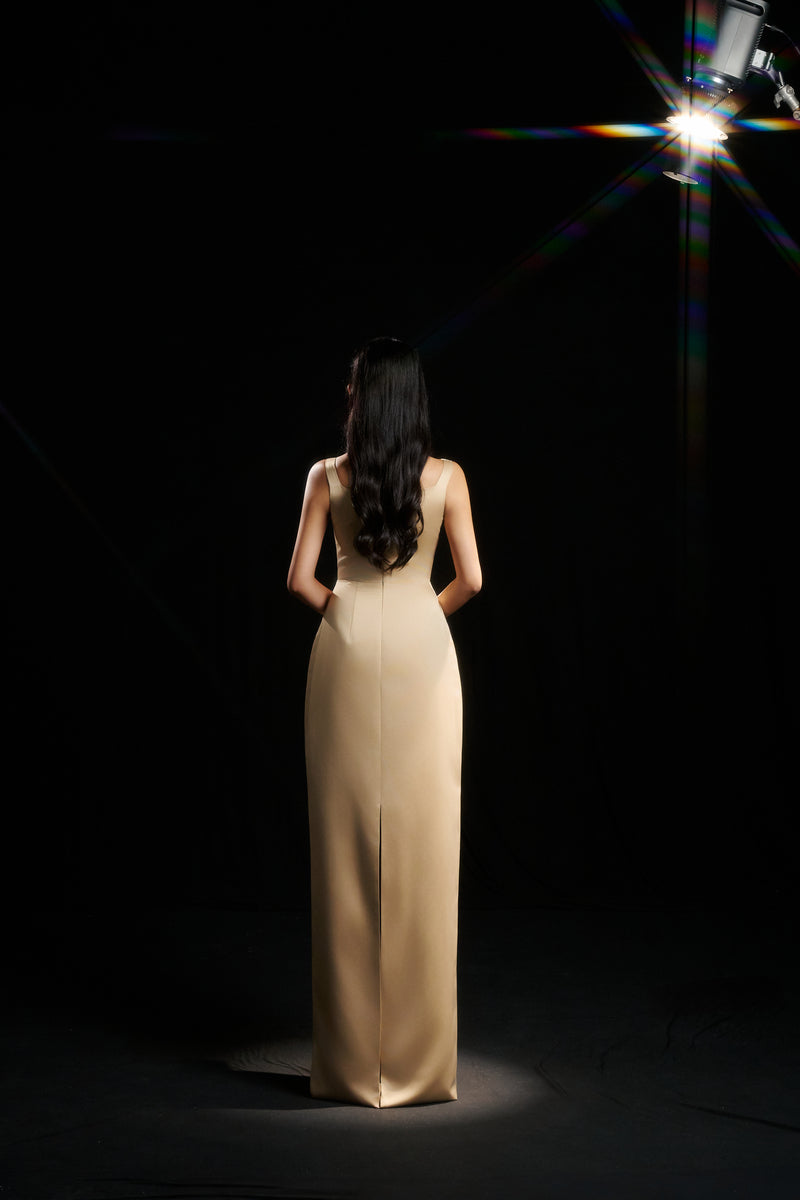 Light yellow Amelia strap gown by HACCHIC COUTURE with flowing fabric and elegant design, shown on a model.
