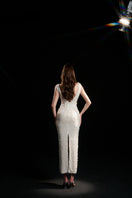 Elegant ivory pearl floral sequin gown by HACCHIC COUTURE, featuring intricate floral embellishments and a flowing silhouette.