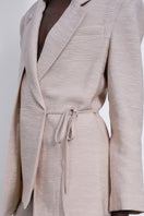 SÉLONE Helia wrap blazer in stone color, tailored blazer with a structured fit, featuring a wrap design and long sleeves.