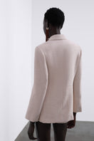 SÉLONE Helia wrap blazer in stone color, tailored blazer with a wrap design and structured fit, shown on a model.