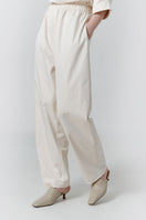 Gray-beige structure pants by DELEGAN, high-resolution image showing tailored pants with a structured fit and subtle detailing.