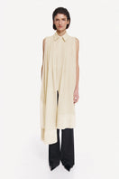 Warm ivory shirt scarf with silk fringe by DELEGAN, showcasing soft fabric and elegant fringe detail.