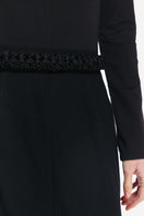 Black midi skirt by DELEGAN, featuring a sleek design and high-quality fabric, perfect for stylish everyday wear.