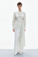Pearl white wrapped blouse from DELEGAN, high-resolution image showing elegant shirt with button details and smooth fabric.