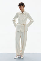 White DELEGAN LINE pants displayed in a high-resolution image, showcasing a sleek, modern design with a tailored fit.