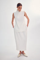 DELEGAN milk-colored cocoon midi skirt with flowing fabric and elegant silhouette, shown in high-resolution image.