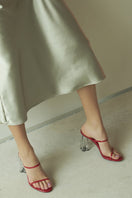 Red patent glass mules sandals by House of Atana, featuring sleek design and comfortable slip-on style.
