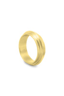 Gold Huna band ring by EDXÚ featuring matte finish with emerald and diamond accents, shown from a side perspective.
