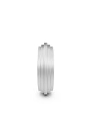 Matte platinum Huna Band ring by EDXÚ featuring emerald and diamond accents, showcased from a side view.
