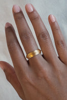Matte gold Huna ring by EDXÚ, showcasing a sleek, minimalist design in a close-up shot.