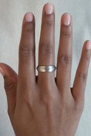 Matte platinum Huna band ring by EDXÚ, showcasing a sleek, minimalist design in close-up.