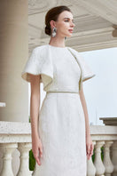 White I.H.F gown with round neckline and exaggerated shoulders, shown in size XXS. Elegant and stylish formal dress.