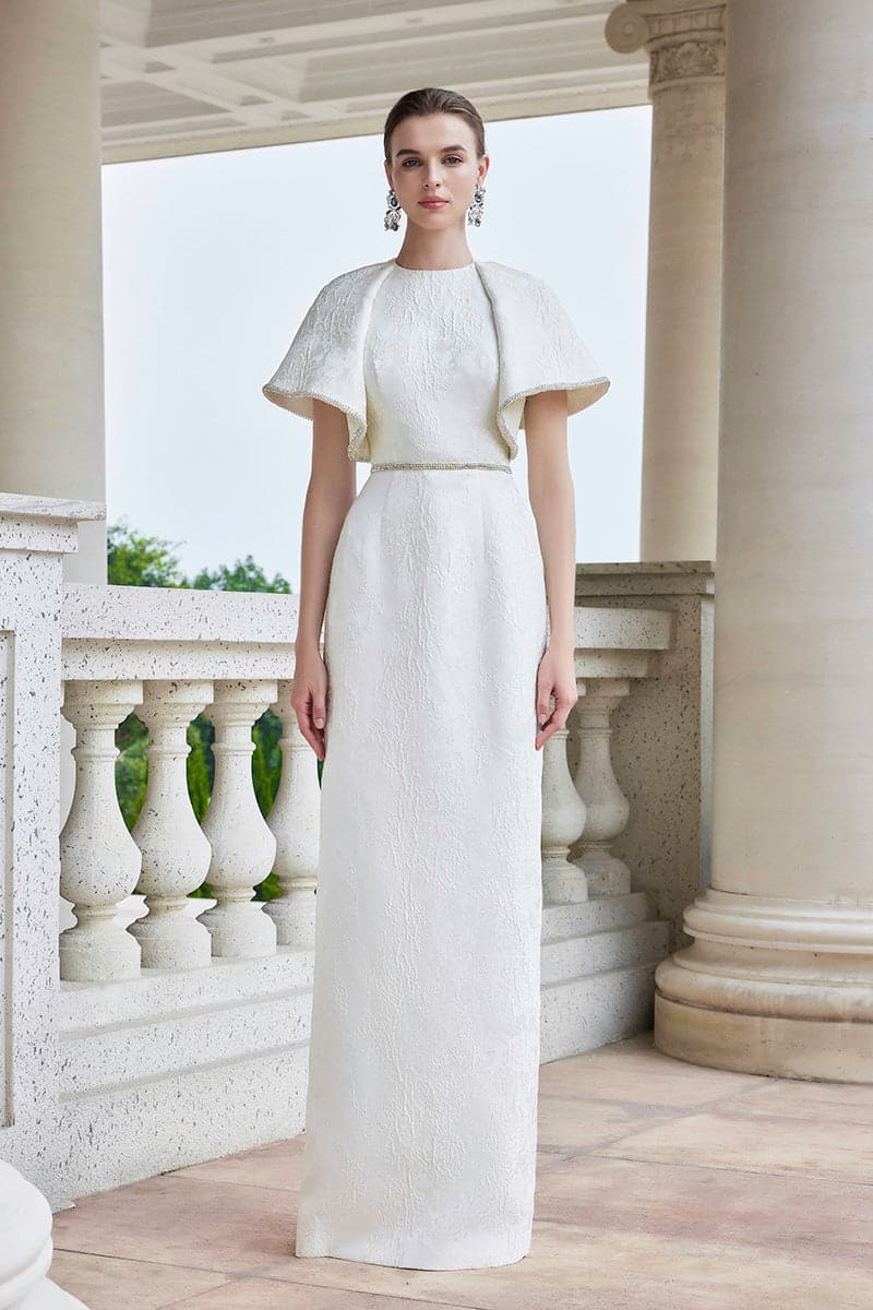 White I.H.F gown with round neck and exaggerated shoulders, showcasing a stylish and elegant design.