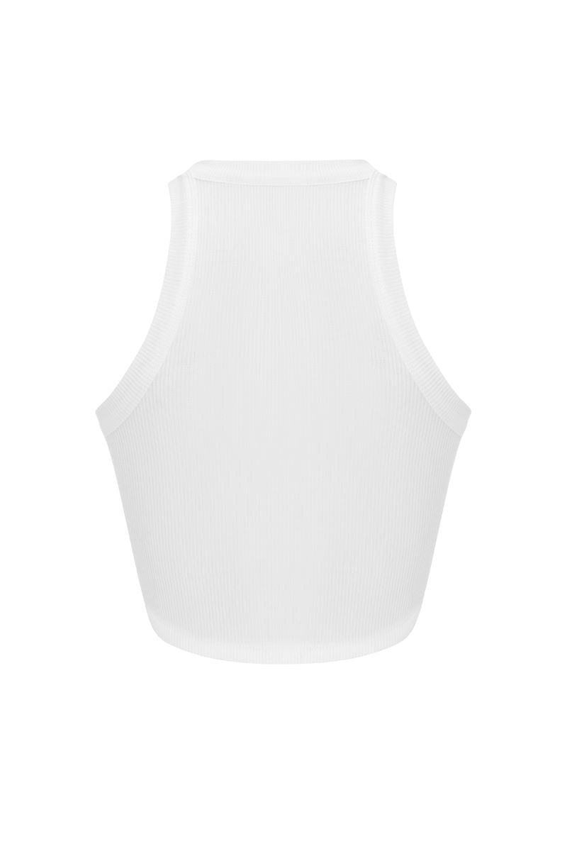 Light pink IKINITA Sunrise Top displayed on a hanger, showcasing its soft fabric and stylish design.