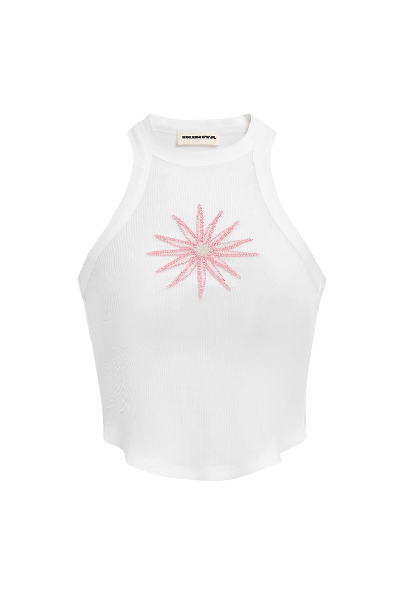 Light pink IKINITA Sunrise Top displayed on a hanger, showcasing its soft fabric and stylish design.