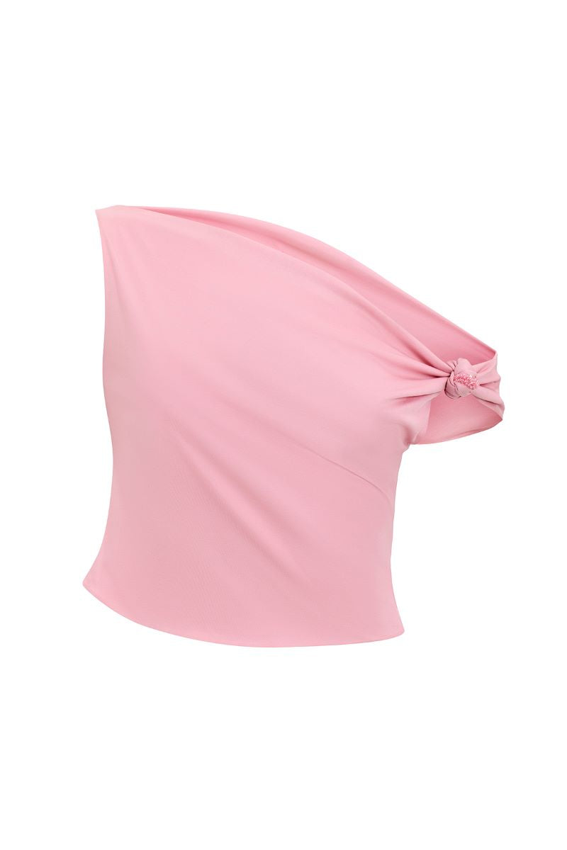 Baby pink "The Fool" top by IKINITA displayed on a hanger, featuring soft fabric and stylish design.