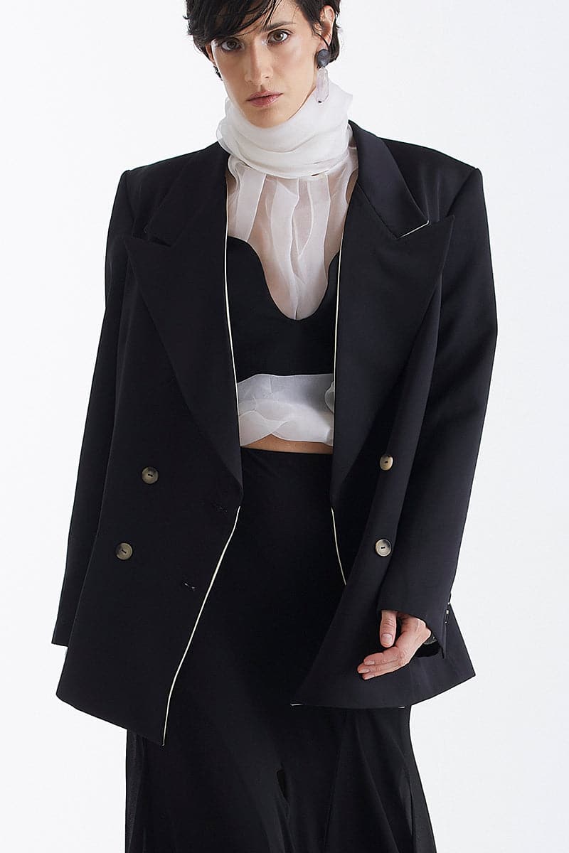 Black trimmed lapel blazer by Babukhadia, tailored fit with classic lapel design, shown on a model.