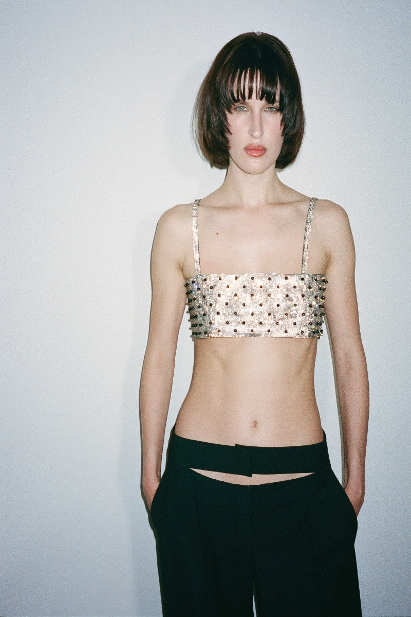 Nué Charlotte Polka-Dot Crystal Top shown on a model, featuring a stylish polka-dot pattern and elegant crystal detailing.