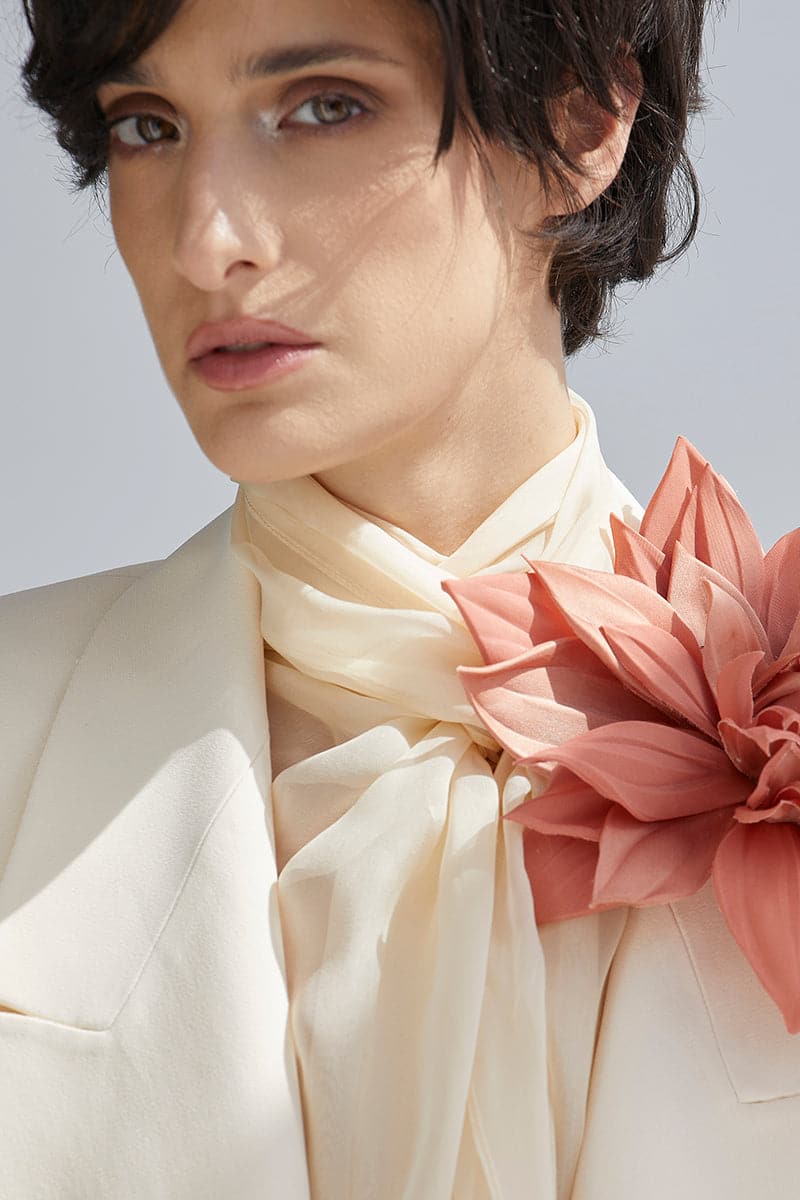 White wide lapel blazer by BABUKHADIA, featuring a tailored fit and classic design, displayed on a mannequin.