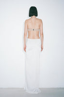 White Blanche maxi skirt by Nué, flowing fabric with a high waist and elegant design, perfect for stylish summer outfits.