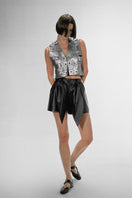 Double A Aiden studded washed silver leather vest with silver hardware and a fitted design, displayed on a hanger.
