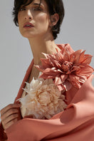 Orange wide lapel coat by Babukhadia, stylish outerwear with a tailored fit and bold color, displayed on a hanger.