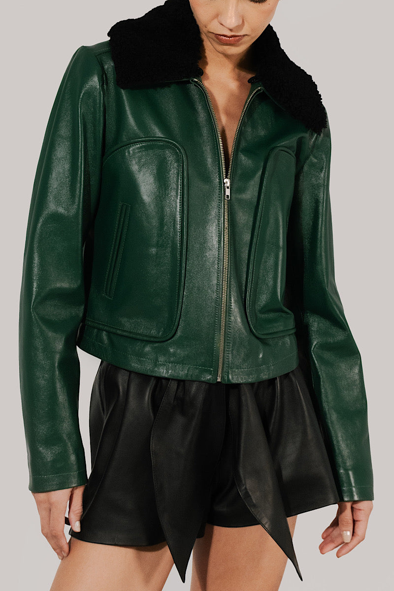 Double A olive leather jacket featuring a stylish emery finish, classic collar, and zip closure, displayed on a hanger.