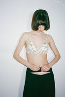 Nué MIMI Bullet Bra in white and black, featuring soft fabric cups and adjustable straps, displayed on a neutral background.