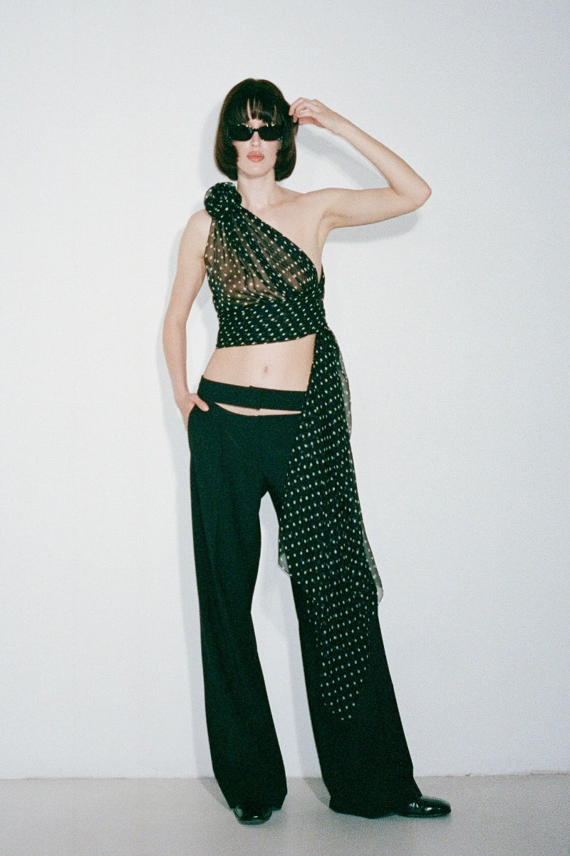 Black HELOÏSE top by Nué, featuring a fitted design with a stylish neckline, displayed on a neutral background.