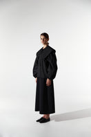Black collar shirt by DELEGAN, featuring a classic button-up design and tailored fit, displayed on a plain background.