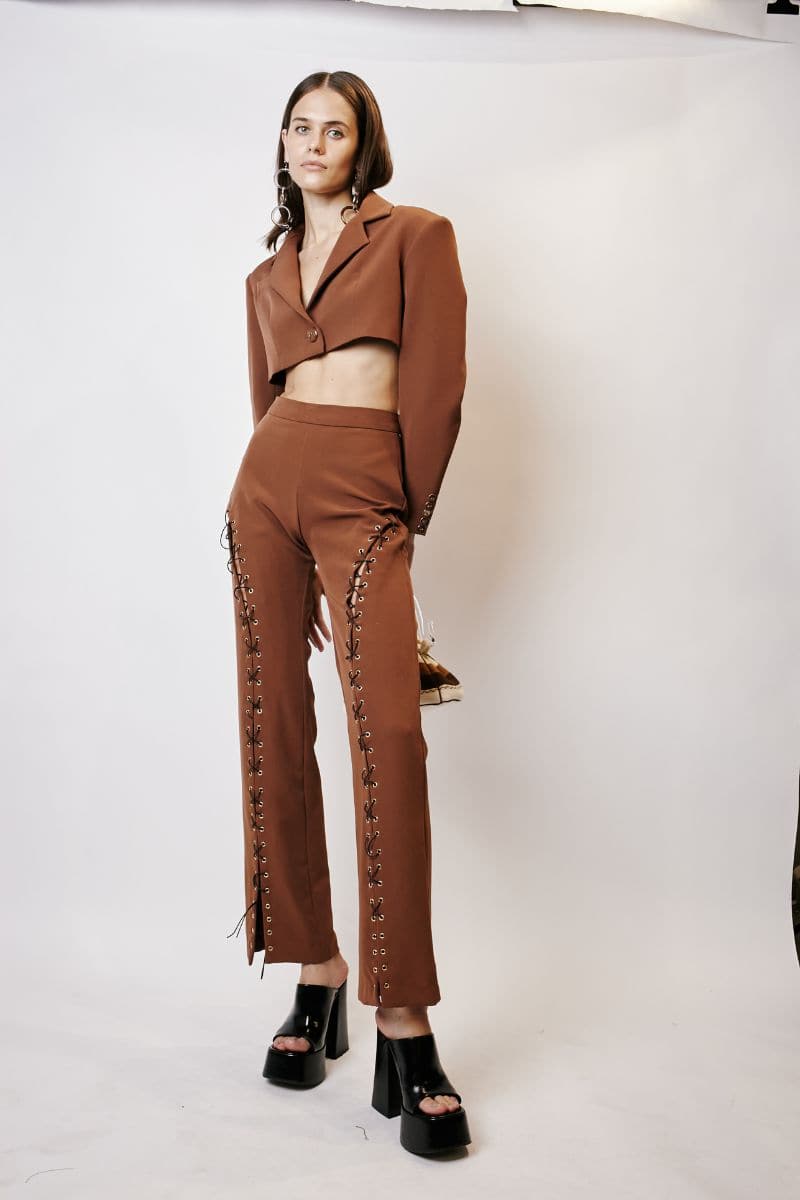 Brown cropped blazer by JC Pajares, tailored fit with lapel collar and long sleeves, styled on a white background.