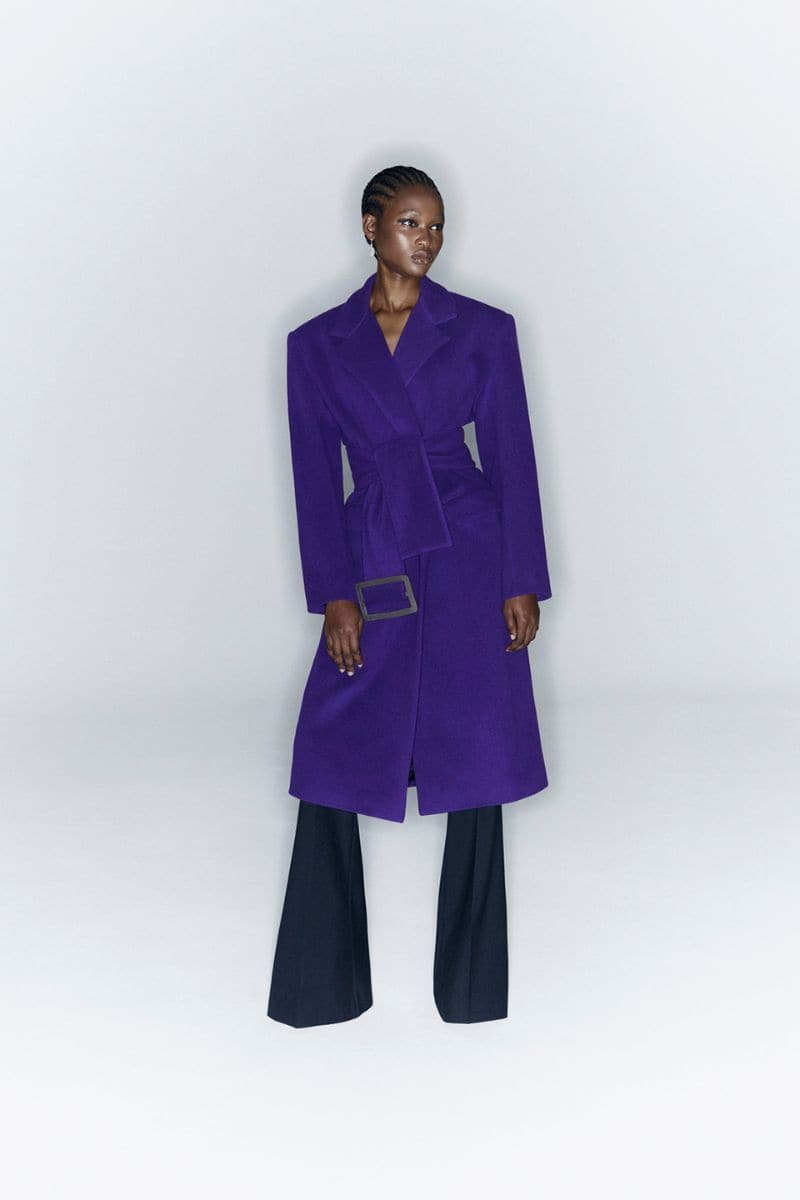 Oversize purple wool and cashmere coat by JC Pajares, shown on a hanger with a soft, textured fabric and relaxed fit.
