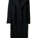 Tailored black coat with side slits by JC Pajares, featuring a sleek design and classic fit for stylish winter wear.