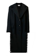 Tailored black coat with side slits by JC Pajares, featuring a sleek design and classic fit for stylish winter wear.