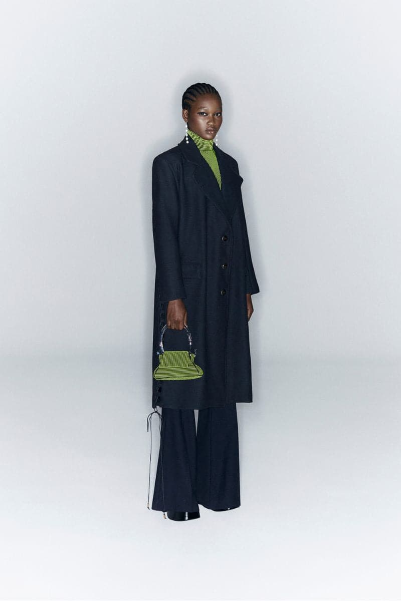 Tailored black coat with side slits from JC Pajares, featuring a sleek fit and stylish design for women.