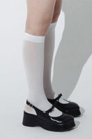 Black Avignon chunky platform heels by Je La Connais, showing stylish black heels with thick soles and ankle straps.