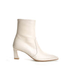 Off-white ankle boots by Je La Connais, featuring a sleek design, low heel, and stylish ankle-length cut.